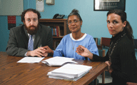 Deborah surrounded by her attorneys